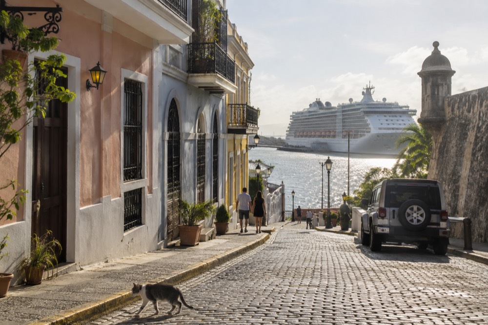 A cruise ship docked in San Juan Bay with the colorful buildings of Old San Juan in the foreground