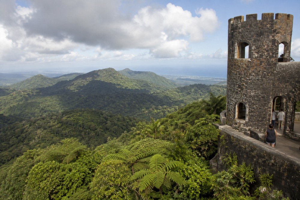 Stone observation tower rising above a sea of green rainforest canopy