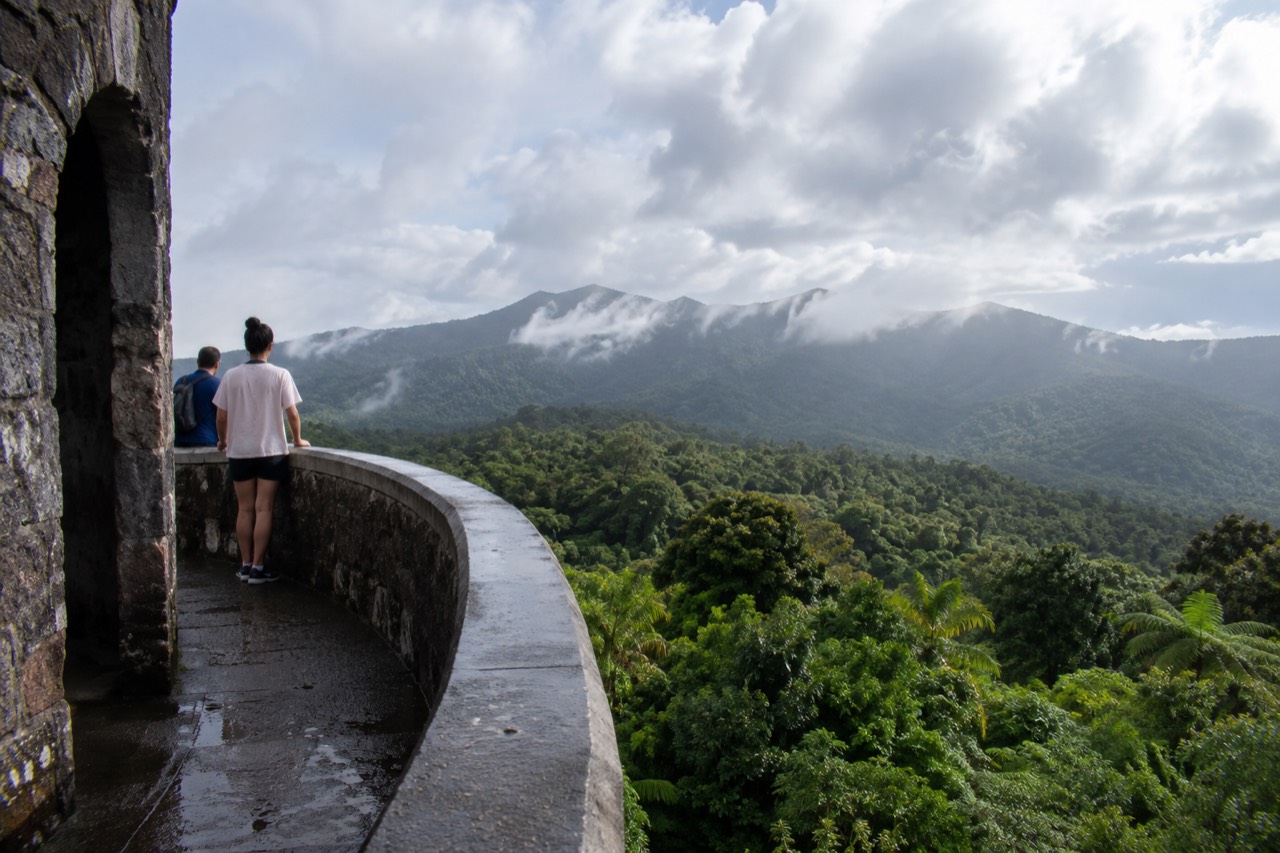 View from the top of Yokahú Tower over dense green rainforest canopy with clouds near the ridge